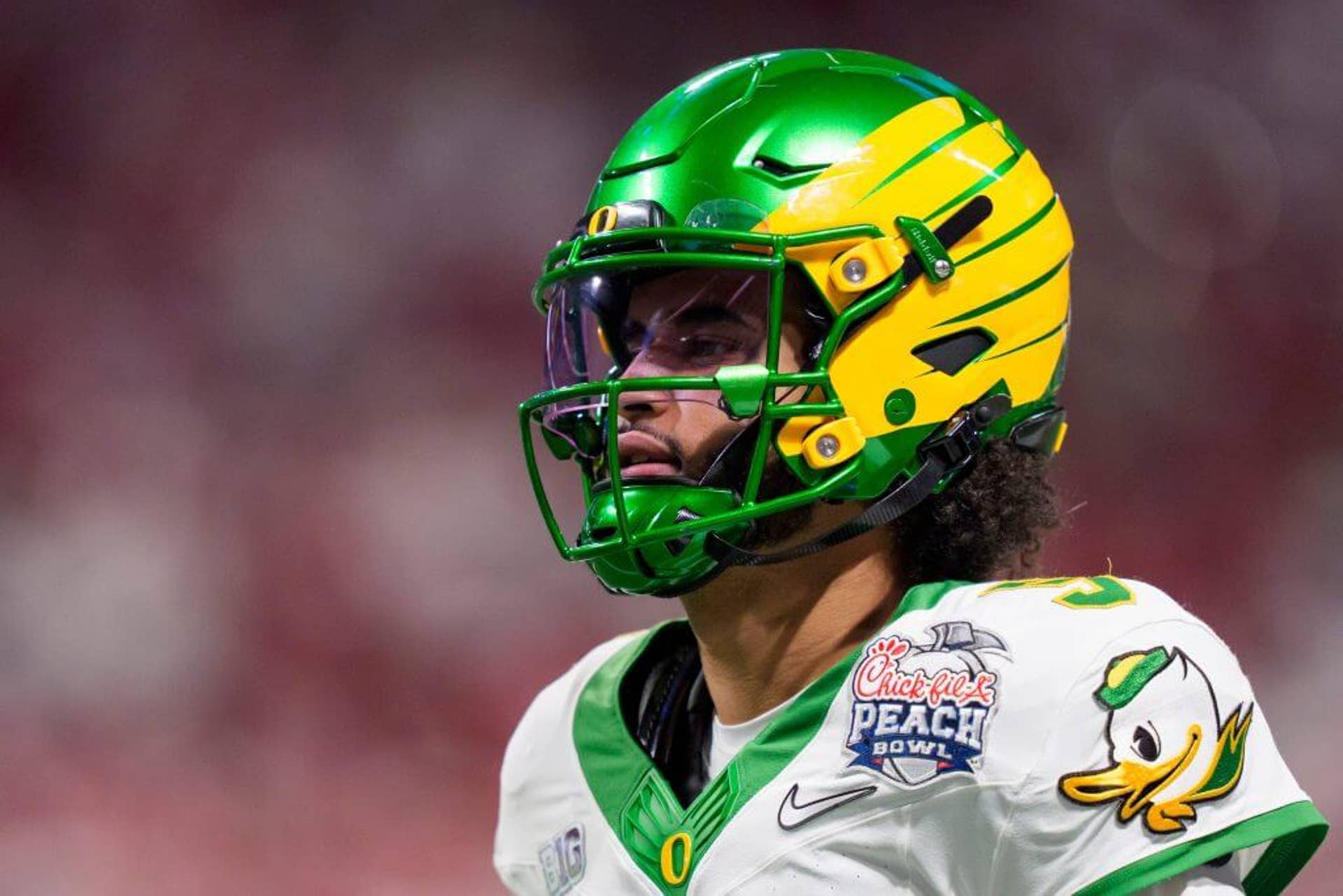 Oregon quarterback Dante Moore warms up before the Ducks face the Indiana Hoosiers in the Peach Bowl.