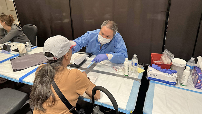 person doing a health test on a patient