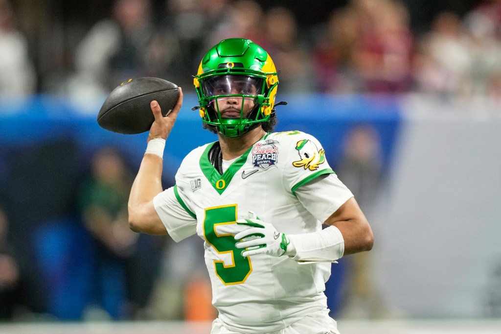 Oregon quarterback Dante Moore (5) passes against Indiana during the Peach Bowl.