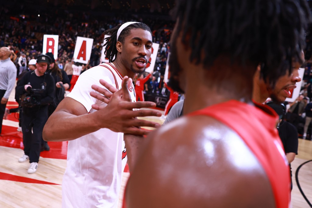 Chicago Bulls player Jaden Ivey high-fives a teammate after a game against the Toronto Raptors.