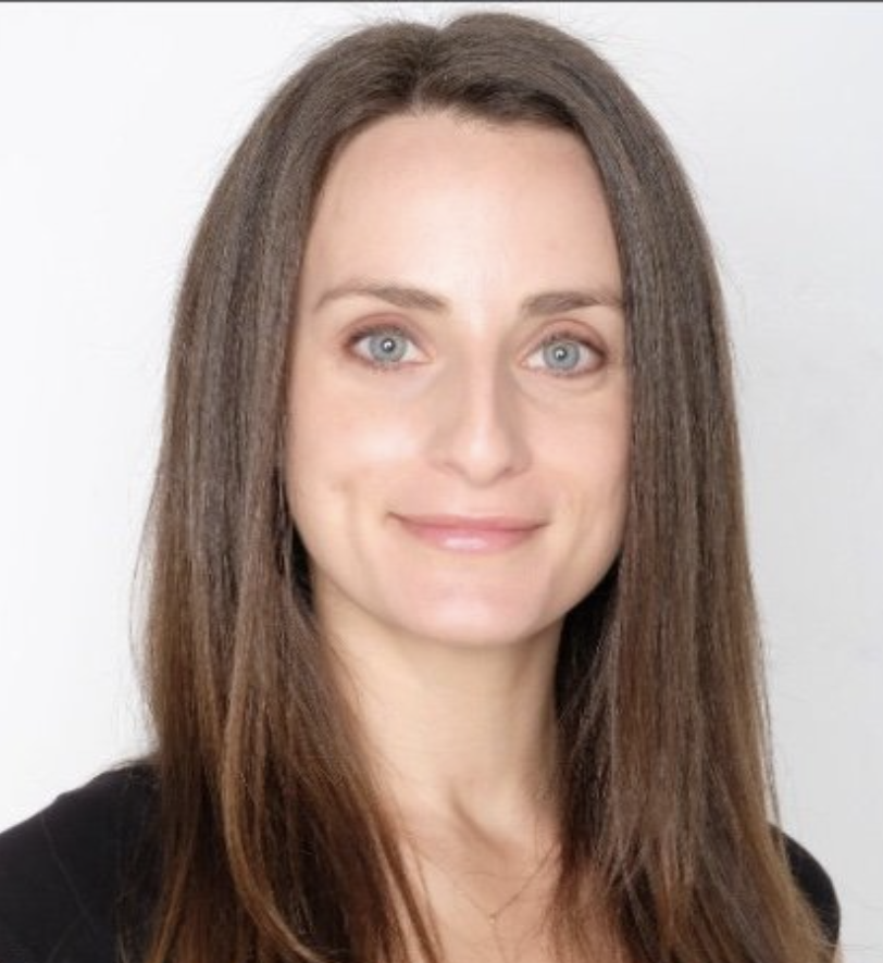 a woman with blue eyes and brown hair in a black t-shirt