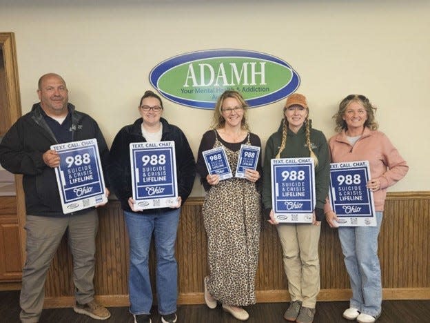 Paint Valley ADAMH Director Melanie Swisher (center) along with representatives of Washington Court House, the Village of Octa, Ross County Park District and the City of Jeffersonville display the signage that will be placed in eight area parks and preserves.