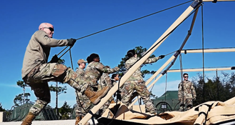 Link to Video: Military personnel setting up  a portable clinic