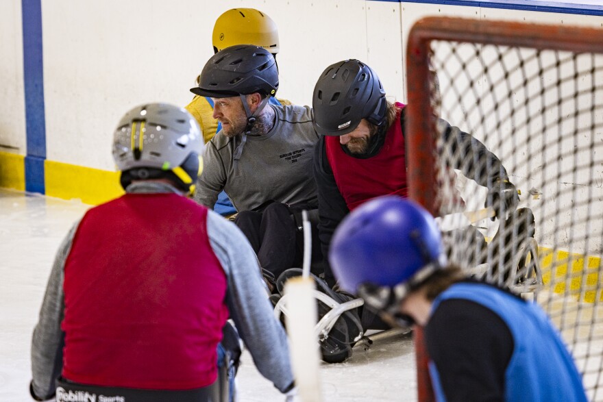 Hotshot Superintendent Ben Strahan (center, gray shirt) and others battle for the puck 