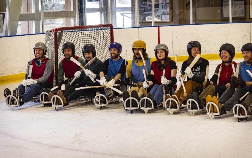 The erstwhile opponents gather for a post-game photo on the ice