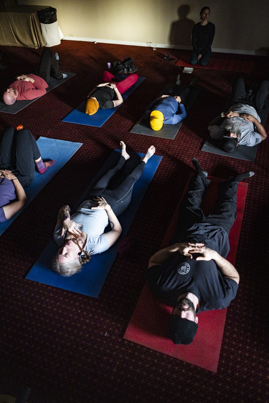 Virginia Avery (bottom center, gray shirt) meditates during a morning session at the Higher Ground retreat
