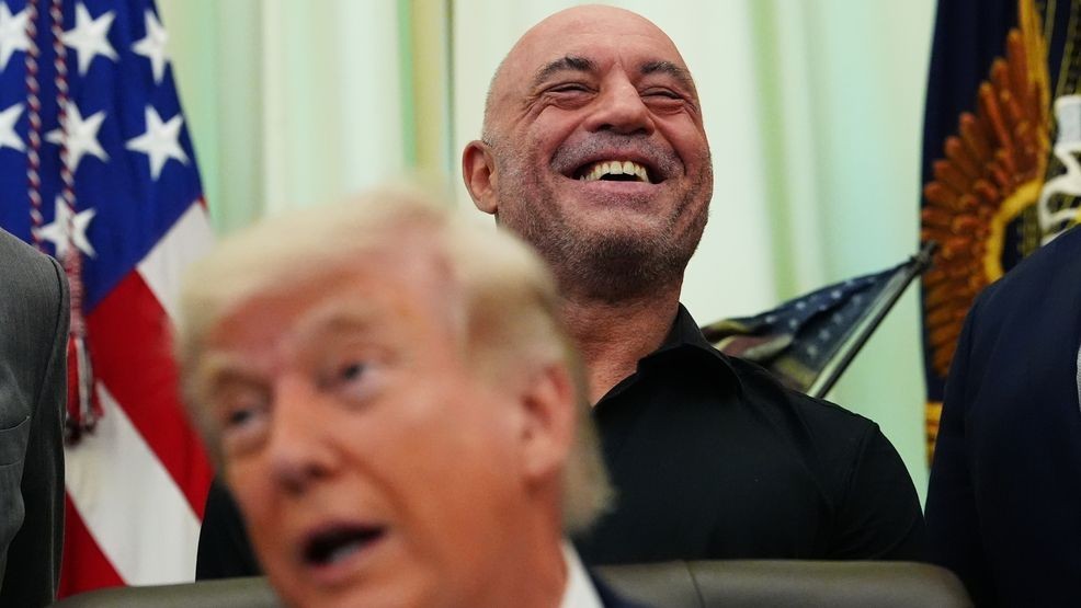 Joe Rogan laughs as President Donald Trump speaks in the Oval Office of the White House, Saturday, April 18, 2026, in Washington. (AP Photo/Julia Demaree Nikhinson)
