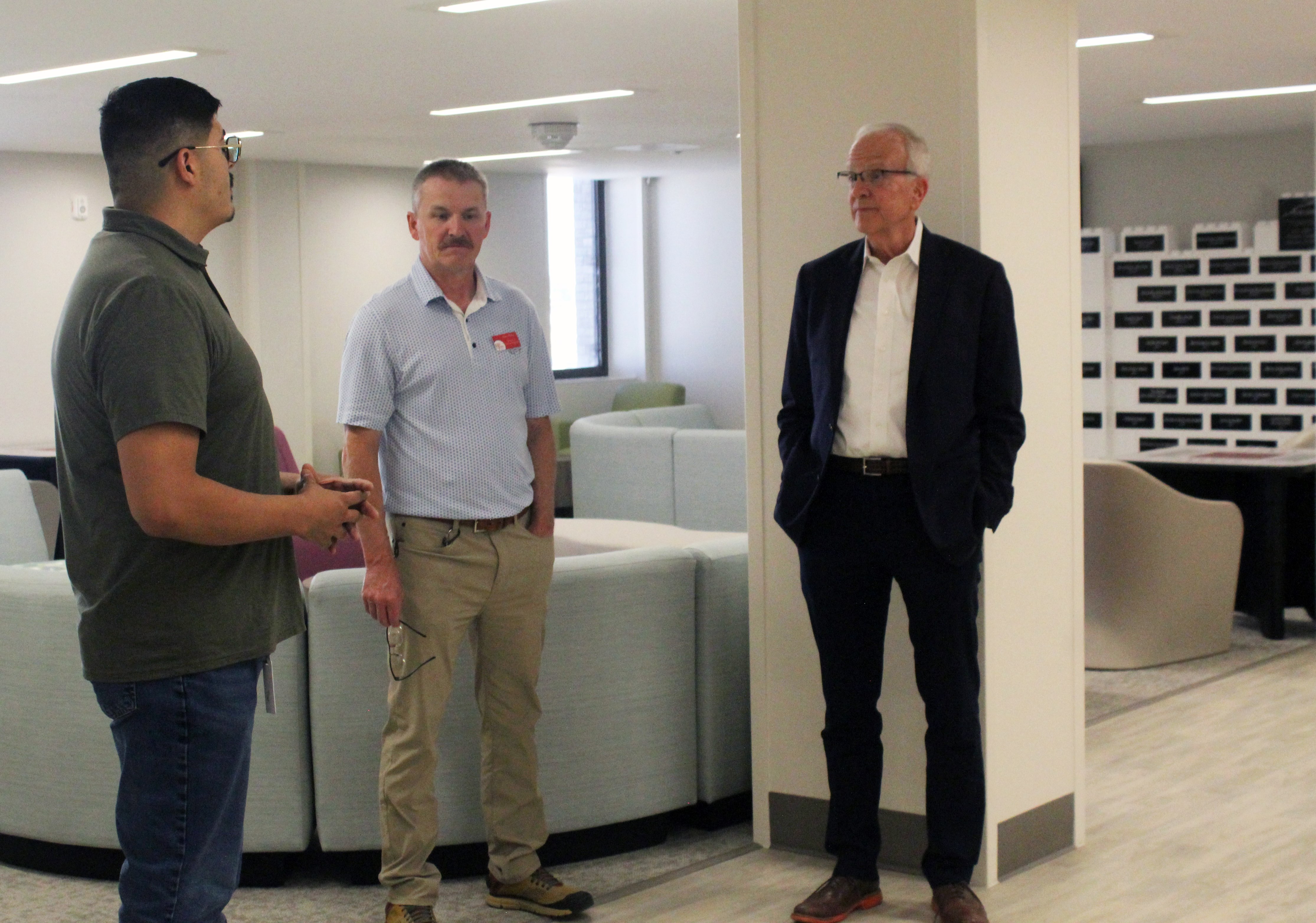 Benito Rivera-Madrid, Crisis Intervention Center operations manager, and Mark Dinkel, High Plains director of clinical programs, discuss the center's programs with Moran in the one of its community rooms. Photo by Cristina Janney/ Hays Post<br>