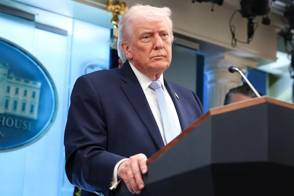 Person at a podium during a press briefing at the White House press room