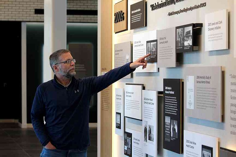 Ryan Pivoney/News Tribune  Joe Pierle, chief executive officer of the Missouri Primary Care Association, points out a piece of history on the wall at the Roy Blunt Center for Healthcare Integration & Innovation on Monday, April 20, 2026. The association and the Missouri Behavioral Health Care Council began settling into the new building in February.