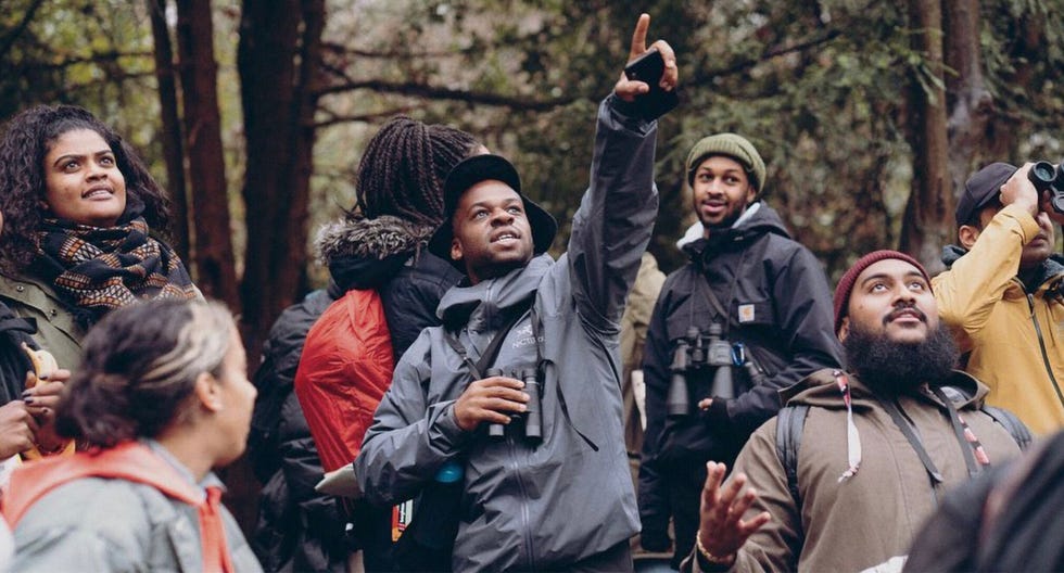 group of people engaging outdoors some holding binoculars