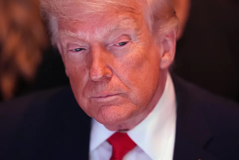 I don't know who this is, but the image shows a person in a suit with a serious expression