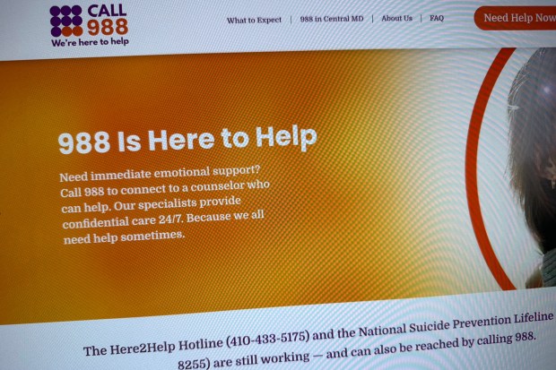 Part of the 988helpline.org website is photographed.