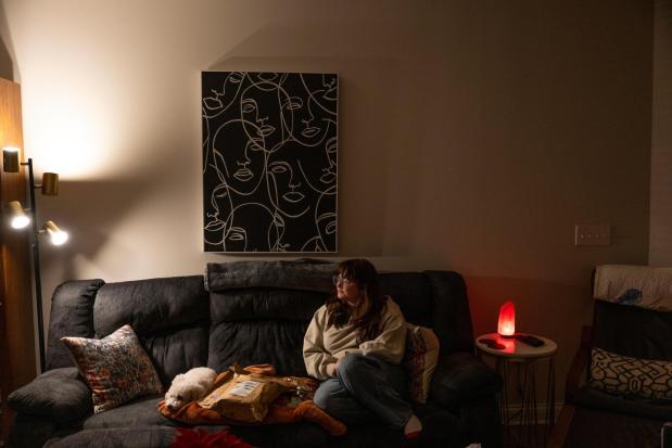 Kate poses for a portrait in her apartment in Kentucky.