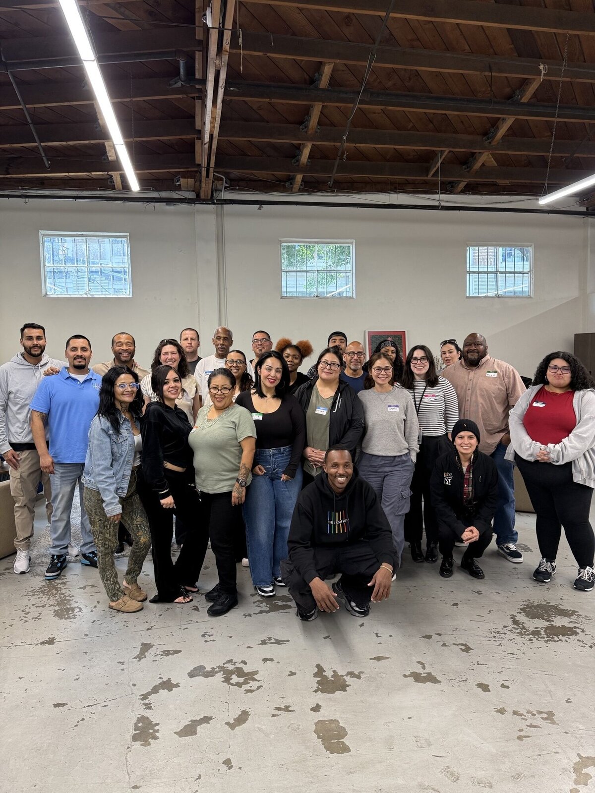 A group of people wearing name tags pose together.