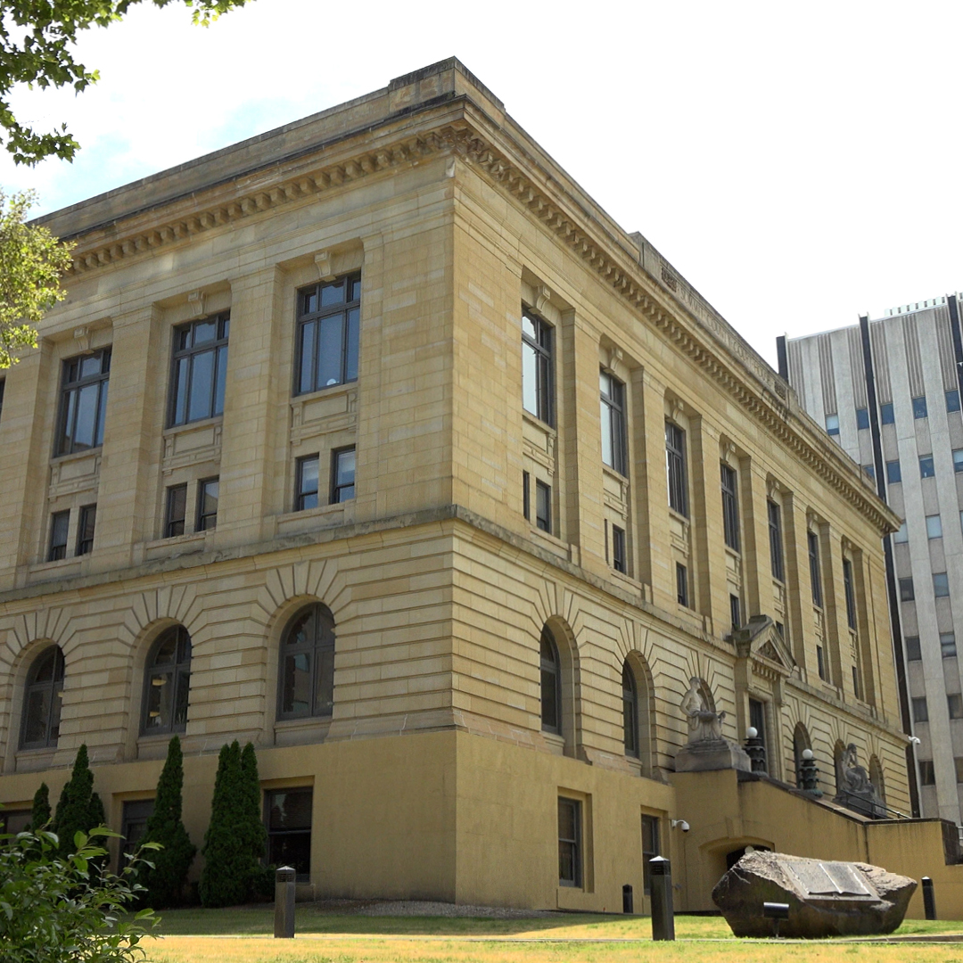 The exterior of a courthouse with green grass