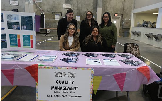 WSP-RC health and wellness fair for the incarcerated population with staff at a booth.