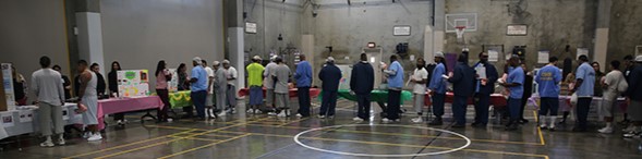 Incarcerated people line up to check out the information for the health fair at Wasco prison.