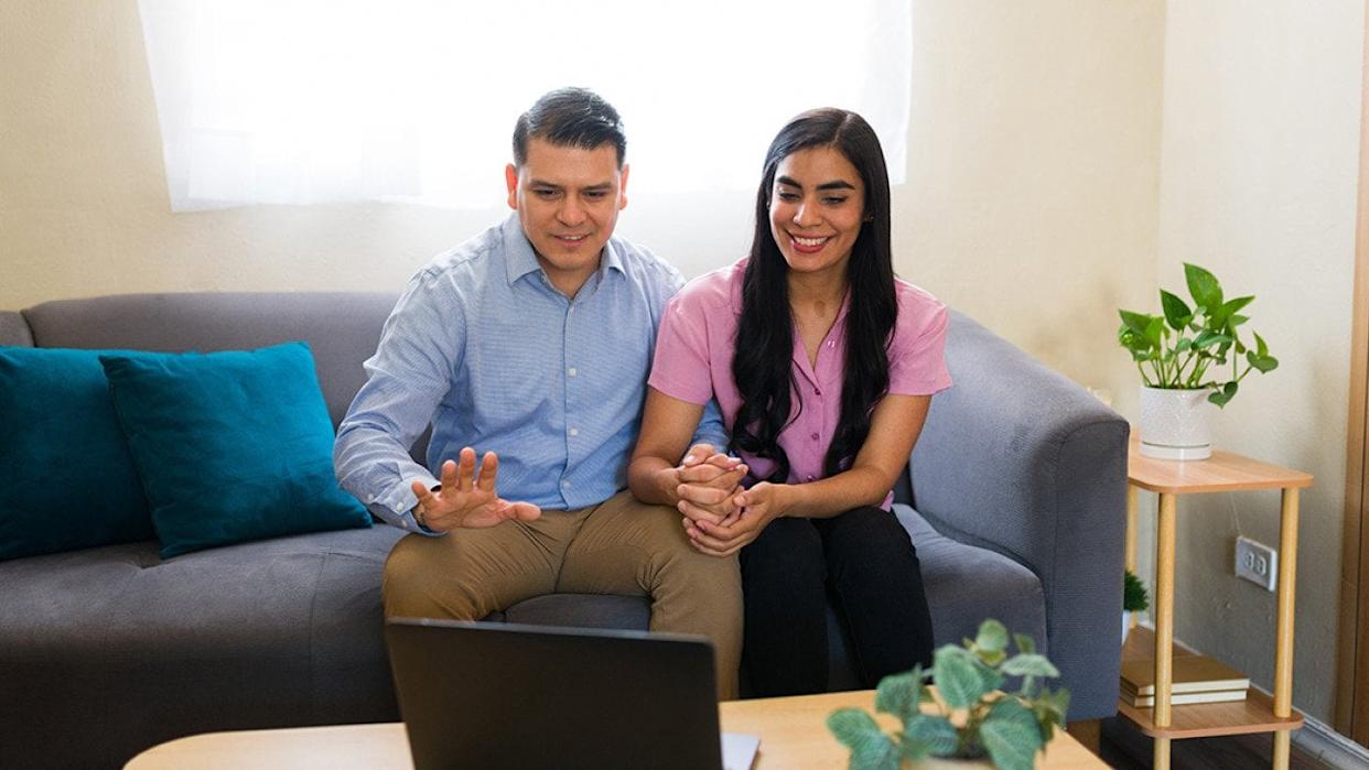 A couple at home attending a virtual therapy session. - antoniodiaz // Shutterstock
