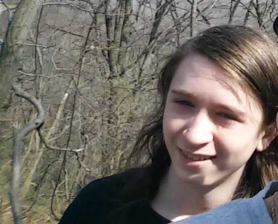 Bailey Piersing standing outside.