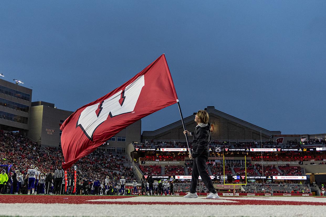 A University of Wisconsin cheerleader waves the school's during a game in 2025. (Dan Sanger / Icon Sportswire via Getty Images file)