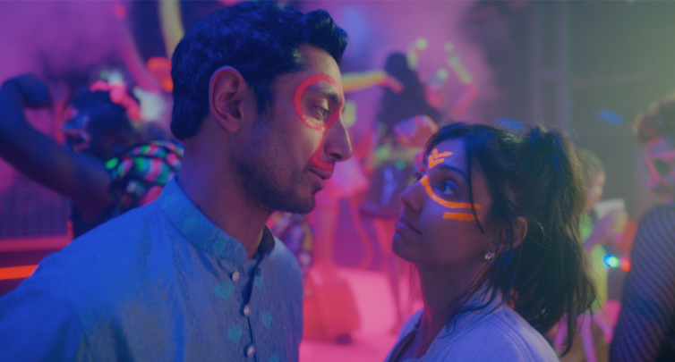 Riz Ahmed and Ritu Arya wearing UV face paint.