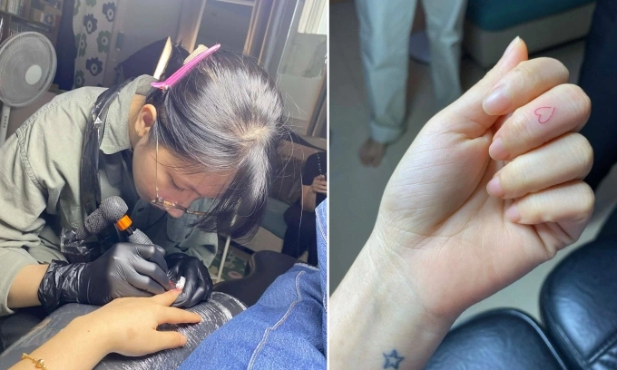 Truc An, from Ho Chi Minh City, has a tattooist marking her left wrist and middle finger to help distinguish directions. Photo courtesy of An
