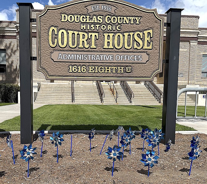 Pinwheel spin at the Douglas County Courthouse on Monday to raise awareness of child abuse on behalf of Court Appointed Special Advocates.