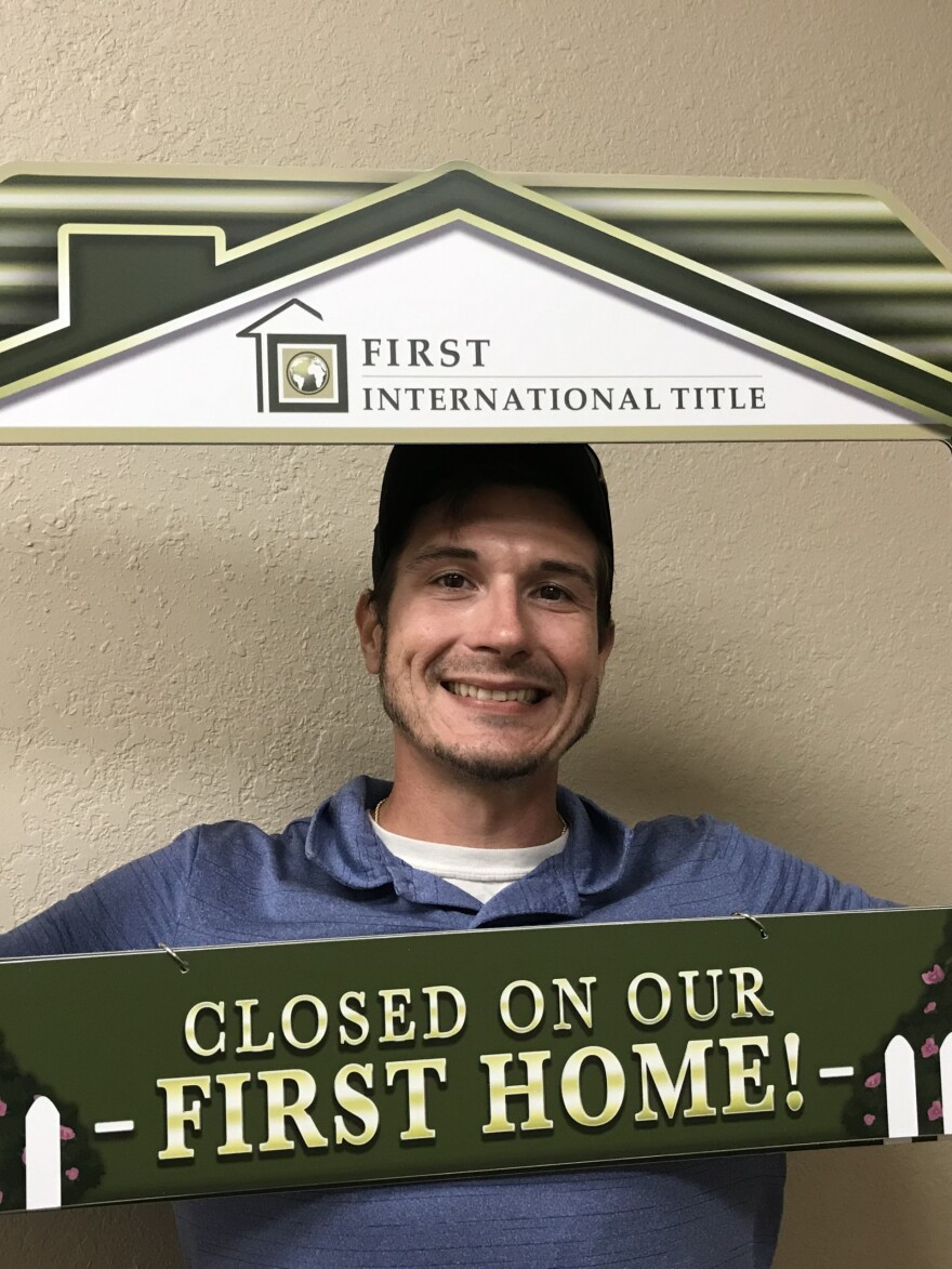 Richard Freshwater celebrates purchasing his first home in Port Charlotte, Florida, in December 2021.