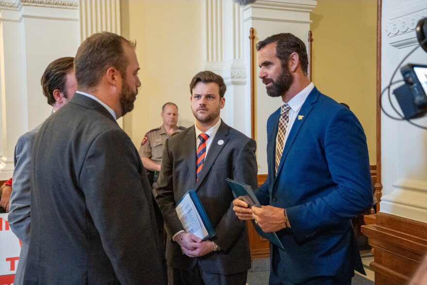 At the Texas State Capitol in 2025, Logan Davidson (center), Marcus Capone of Veterans Exploring Treatment Solutions (at right), and Texas state Rep. John Bucy discuss SB 2308, a law that will fund ibogaine clinical trials.