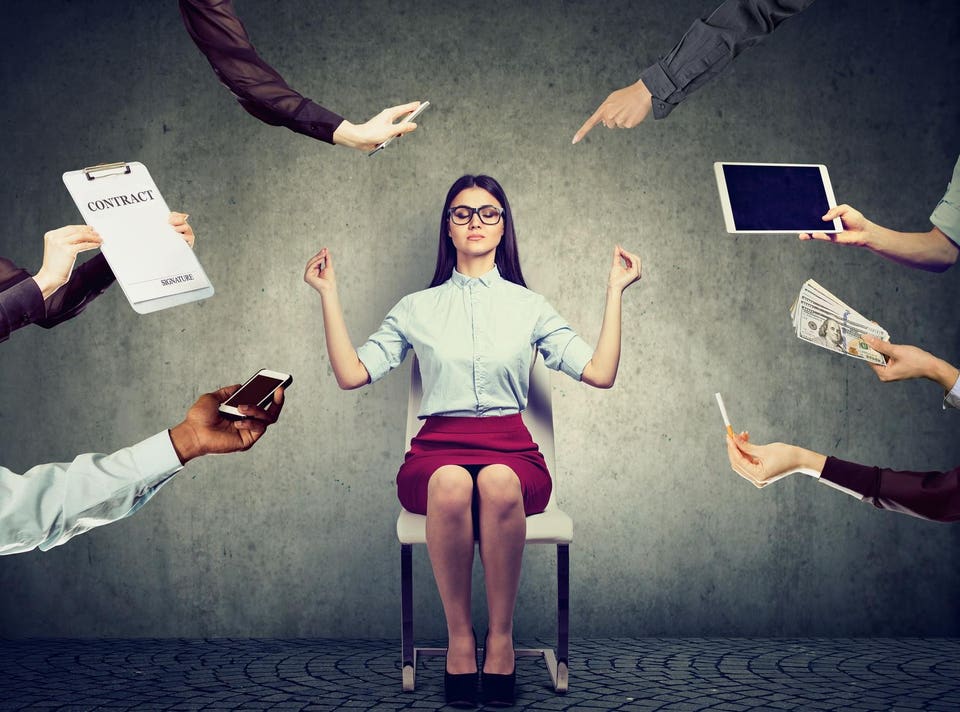 Business woman is meditating to relieve stress of busy corporate life