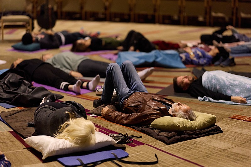 FILE - People partake in a sound bath at Temple Emanuel, Dec. 6, 2025, in Beverly Hills, Calif. (AP Photo/Allison Dinner, File)