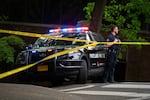 A Portland police officer stands by outside the Multnomah Athletic Club after a vehicle containing explosive devices crashed into the MAC on May 2, 2026.