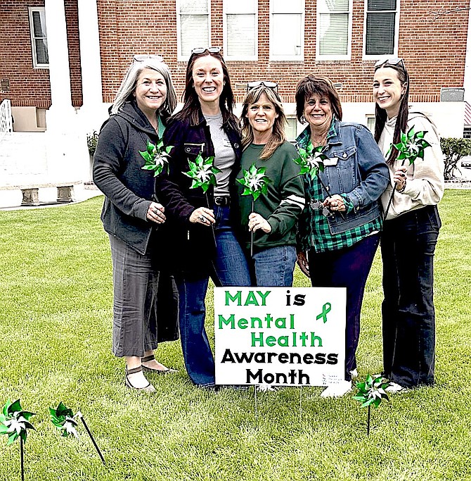 Suicide Prevention Network Staff left to right - Amy Roby, Michelle Simpson, Shauna Willette, Debbie Posnien, and Skyller Rice. Suicide Prevention Network host a pinwheel placing event for Mental Health Awareness month, which is observed in May, in front of the Carson Valley Museum and Cultural Center on May 4.