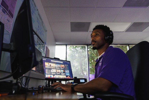 Kibrom Gebregziabher, a clinician, works in the triage room where he receives crisis calls at Telecare's Mobile Crisis Response Team headquarters on Wednesday, May 13, 2026. The center takes calls from 911 and the access and crisis line.(Kristian Carreon / The San Diego Union-Tribune)