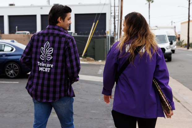 Case manager Luis Bernal and program administrator Bre Lane walk back to their van after speaking with an individual at another Telecare location on Wednesday, May 13, 2026. The team said they would follow up with the person to guide them to needed resources. (Kristian Carreon / The San Diego Union-Tribune)