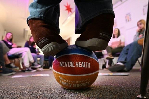 Leah Raffa, prevention specialist and grant coordinator on Denver Public Schools' Substance Use Prevention Program Team, puts her feet on a ball that shows sources of strength for the students to think about during a Sources of Strength workshop at South High School in Denver on March 19, 2025. (Photo by Helen H. Richardson/The Denver Post)