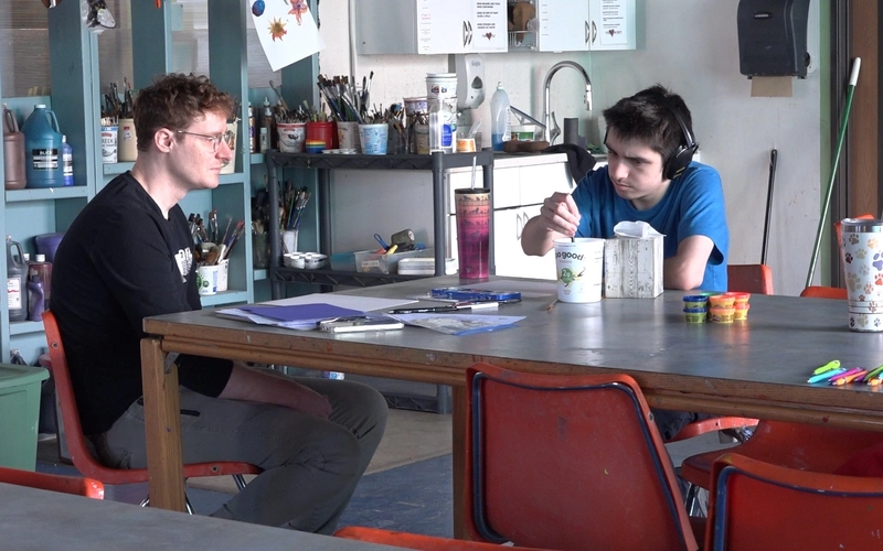 2 People working on a mental health art worksheet