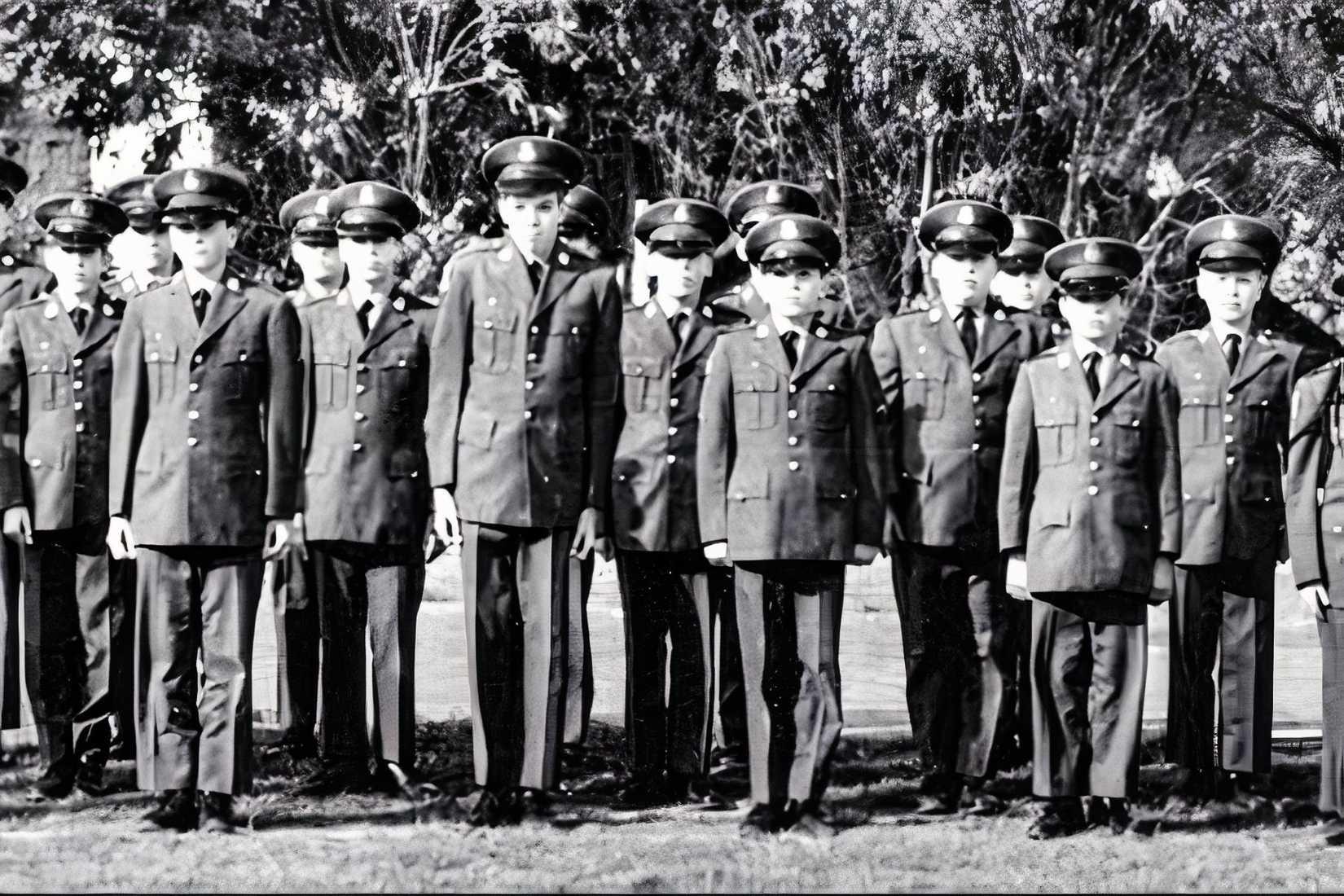 A black-and-white archival image from Fortunate Sons shows young Harvard School students standing in military-style uniforms.