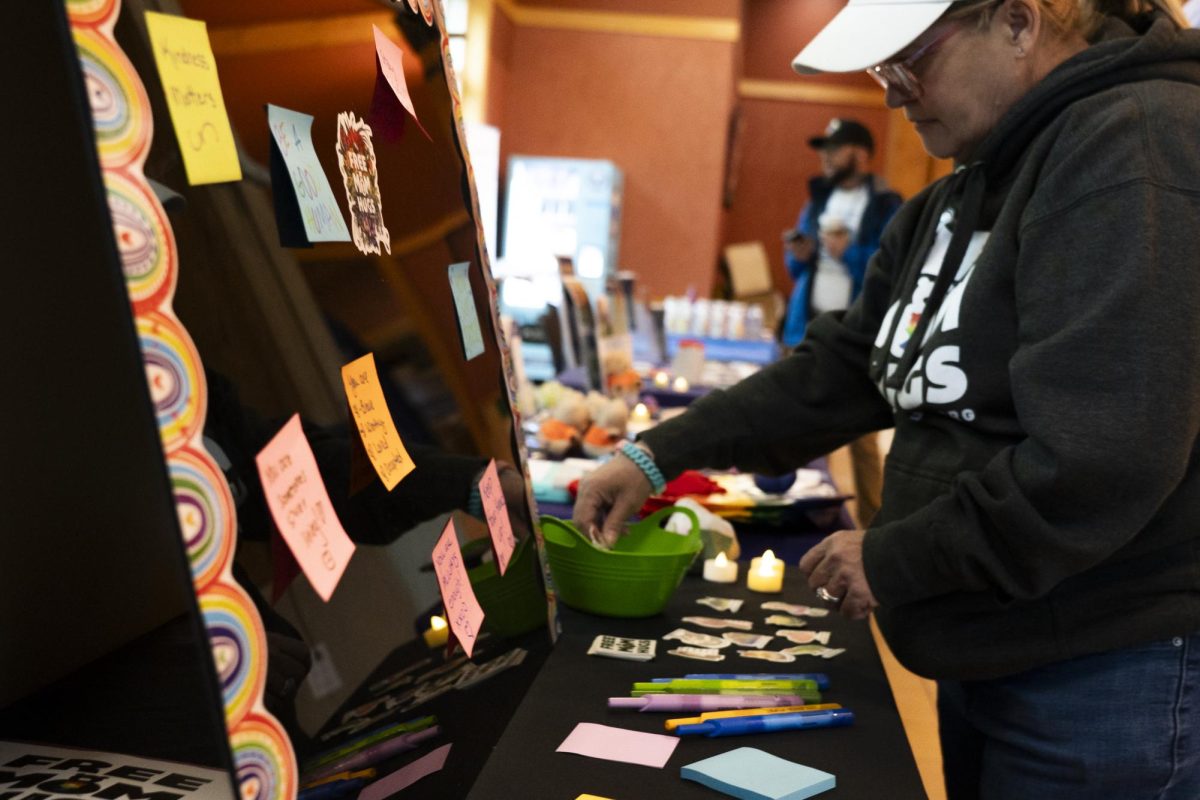 A volunteer sets up a booth before the Out of the Darkness Walk begins at the Bertolini Student Center at Santa Rosa Junior College on April 11, 2026.