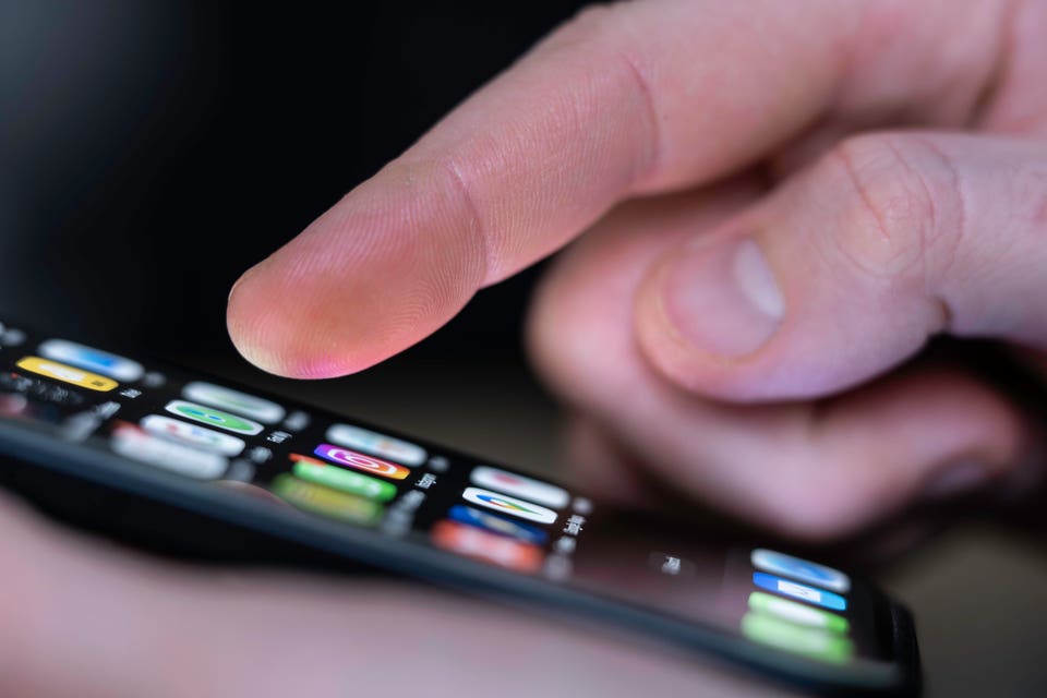 A person with an iphone selecting an app