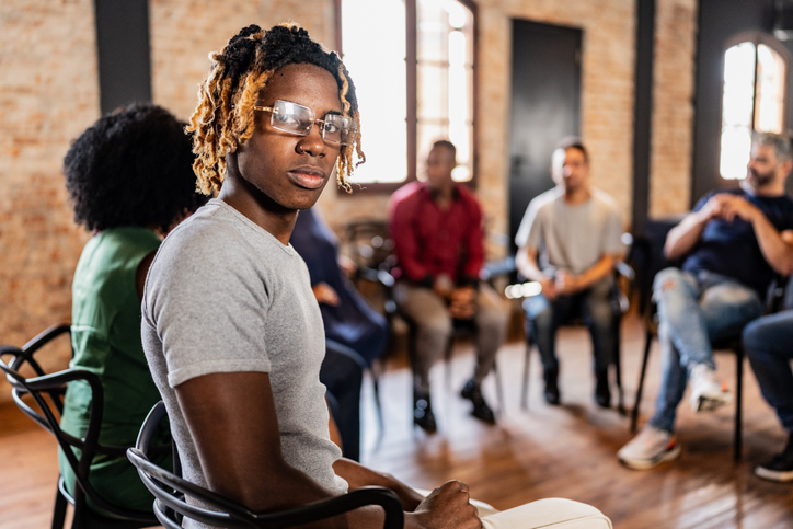 Portrait of a teenager boy on therapy group