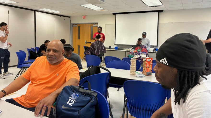 Bernard Macklin, left, talks with student Kyntrel Witherspoon-Dessources at the Barbershop Talk event on April 14.