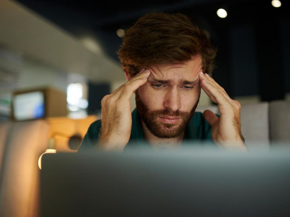 Entrepreneur working on laptop with headache, anxiety and stress while thinking, idea and burnout in a cafe. Mental health and frustrated employee with audit, tax and work mistake in a coffee shop