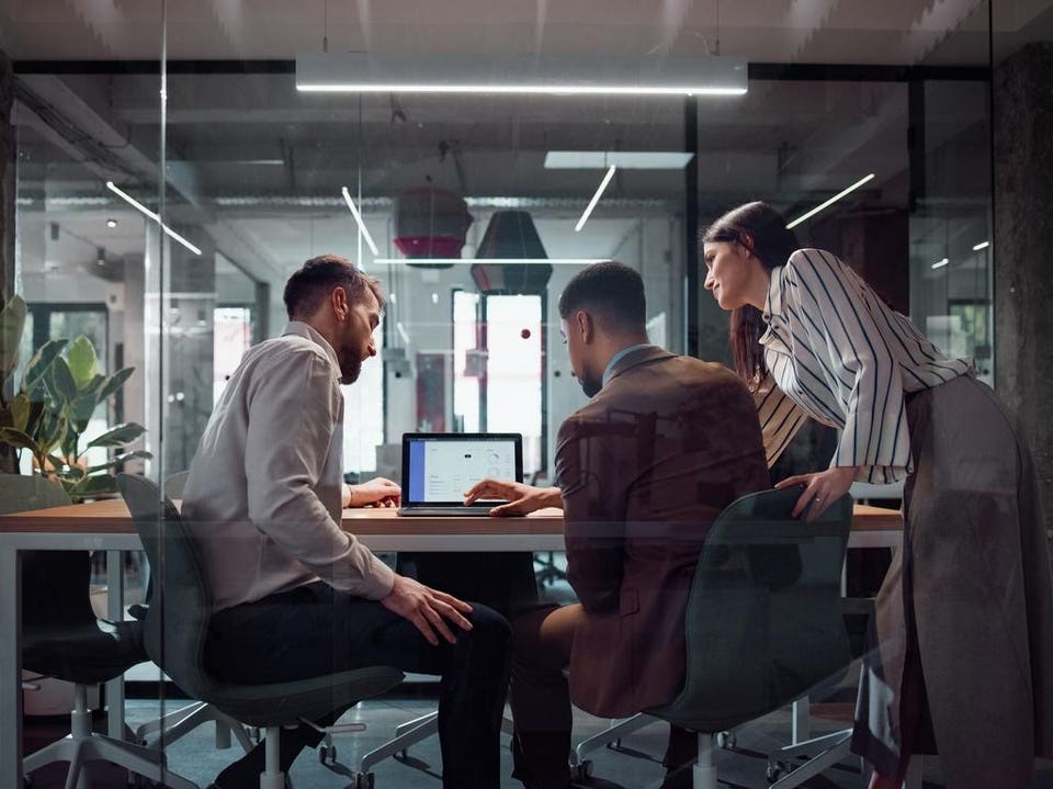 Team Collaboration in a Modern Office with Technical and Digital Discussions