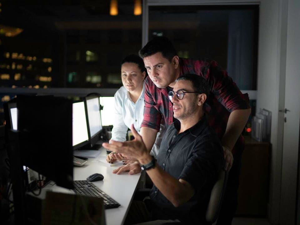 Dedicated team reunited working late at office