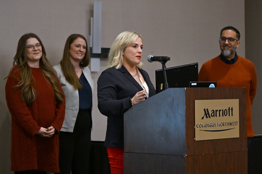 Rachel Canepa takes the podium at the Ohio Department of Behavioral Health's prevention specialist certification ceremony.