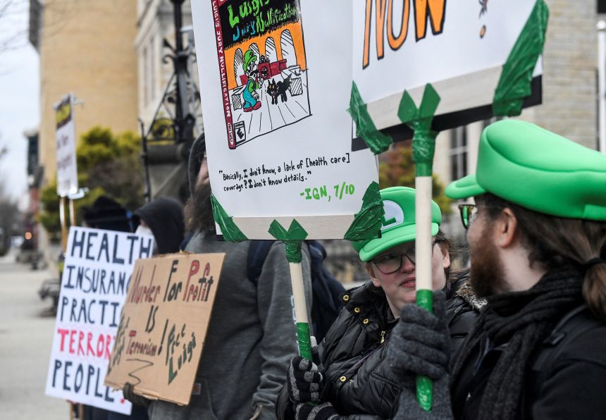 Supporters of Luigi Mangione carried placards and wore the hats of the character Luigi from Nintento's