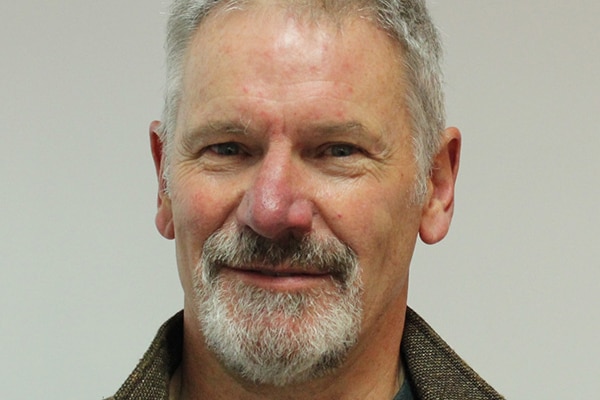 Anthony Smith smiles in close-up photo.