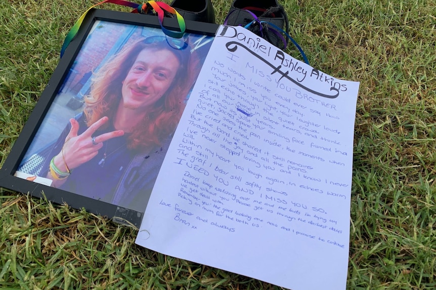 hand written letter next to memorial photo of Daniel Atkins.